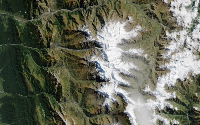 Satellite view of snow-capped mountains and valleys