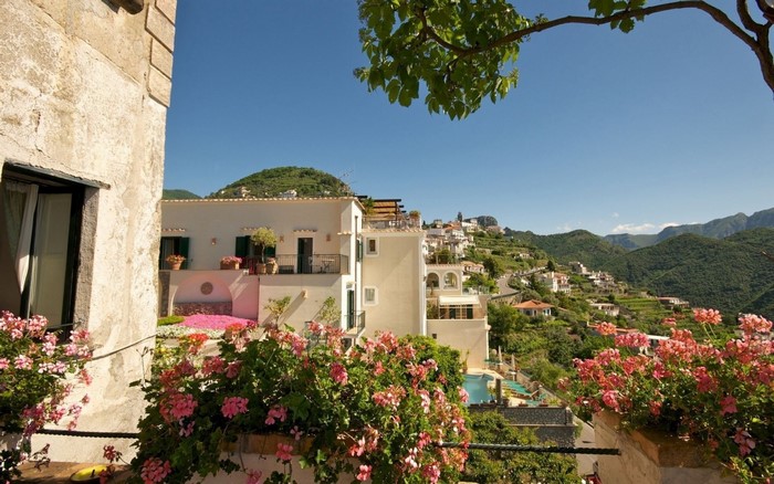 Village on a hillside with flowers and a pool