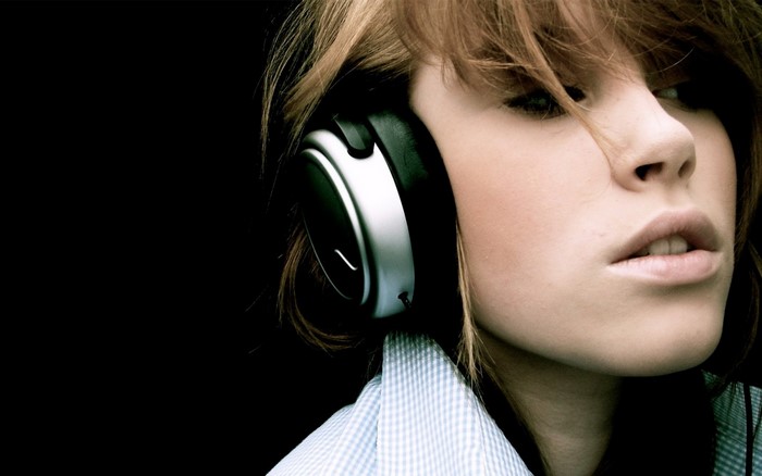 Woman wearing headphones, close-up portrait