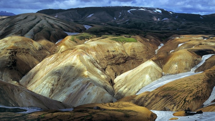 Colorful mountain landscape with snow patches