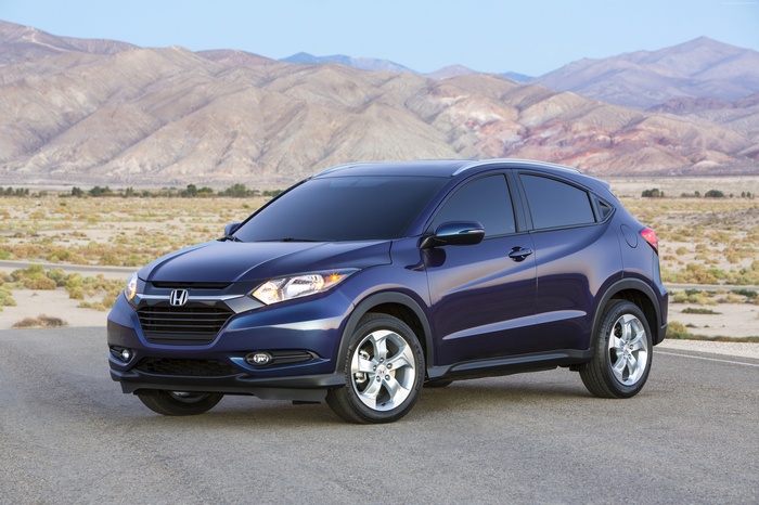 Blue Honda HR-V crossover SUV parked on a road with mountains