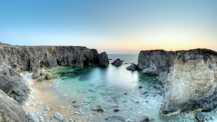 Rocky bay with clear turquoise water and cliffs