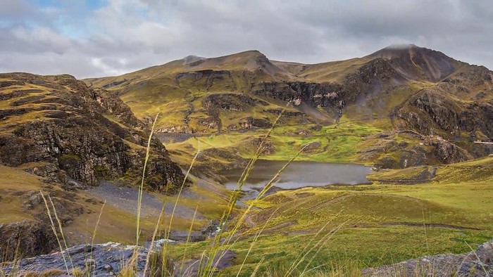 Mountainous landscape with a lake and rolling hills