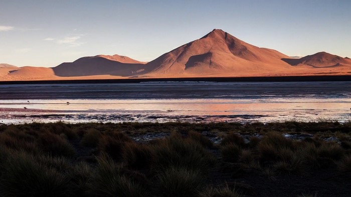 Desert lake with mountains at sunset
