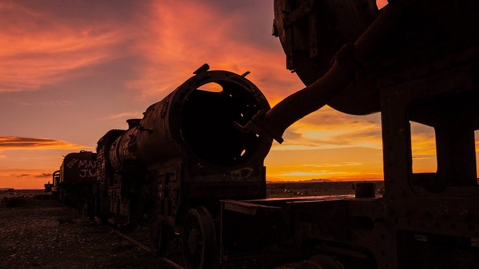 Abandoned train graveyard at sunset