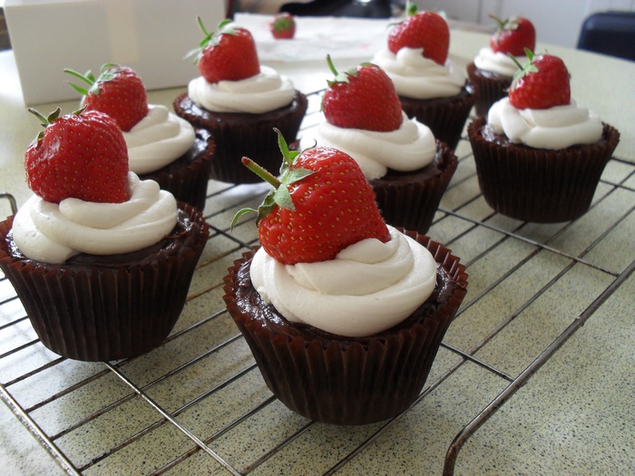 Chocolate cupcakes with strawberries and whipped cream