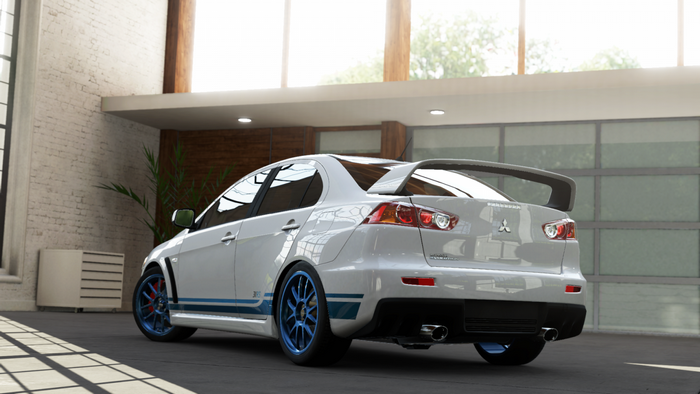 White Mitsubishi Lancer Evolution X with blue rims