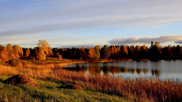 Autumn landscape with lake and forest at sunset