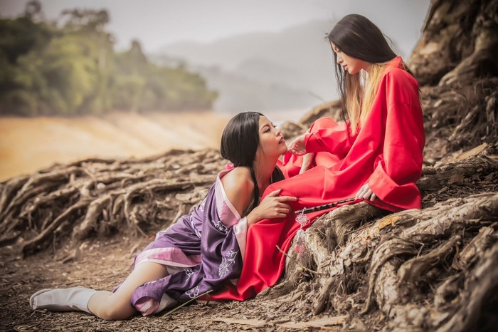 Two women in traditional Japanese attire by a river