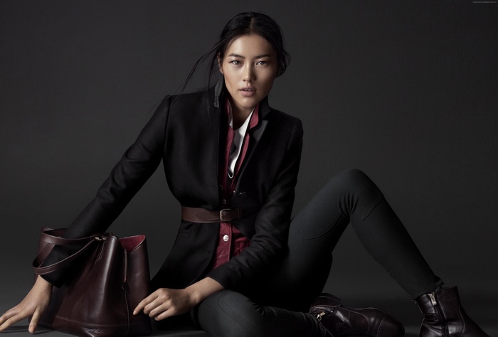 Liu Wen in a black suit with a brown belt
