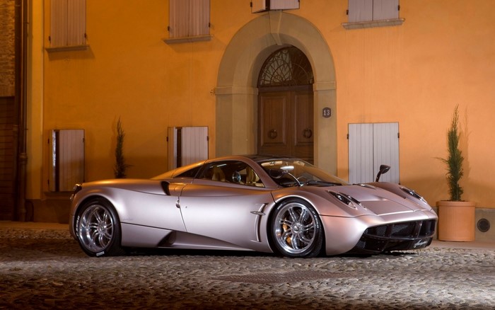 Pagani Huayra sports car parked outside building