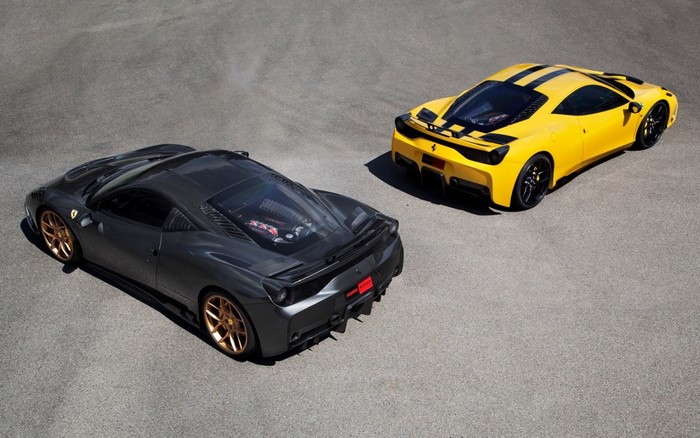 Two Ferrari sports cars, one gray and one yellow