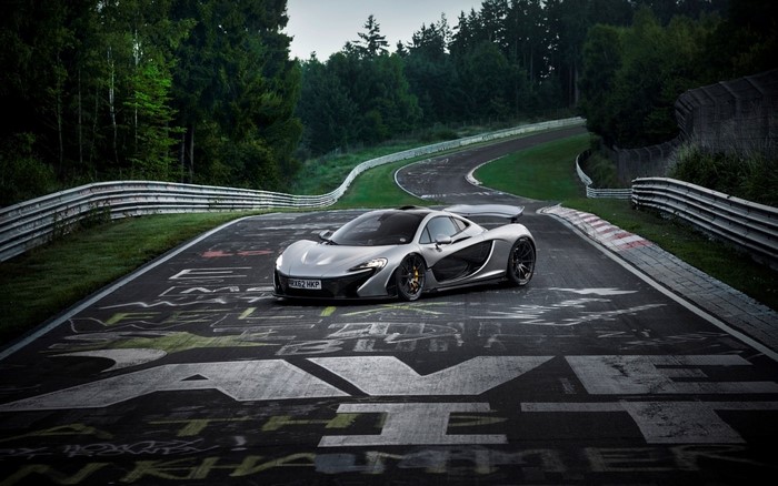 Silver McLaren P1 supercar on a race track