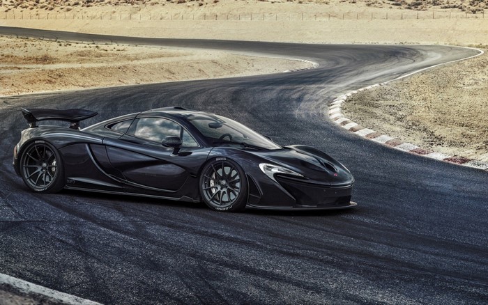 Black McLaren P1 sports car on a race track