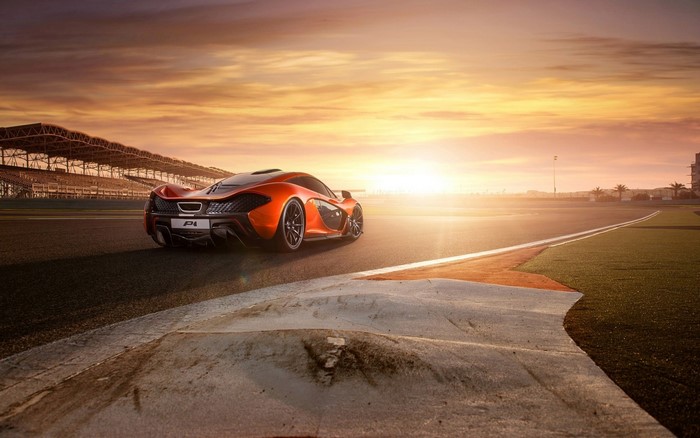 McLaren P1 sports car on a race track at sunset