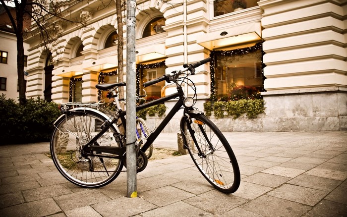 Bicycle parked on a sidewalk in front of a building