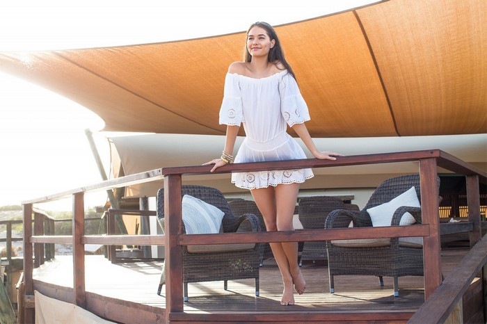 Woman in white dress on a wooden deck