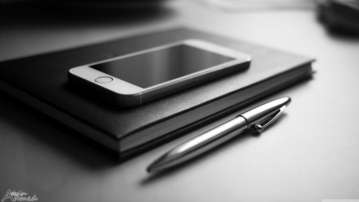 iPhone on notebook with pen