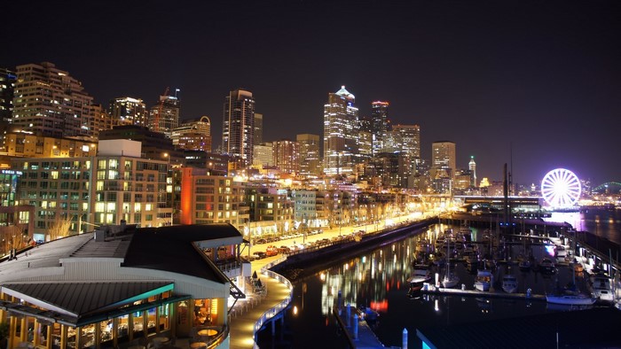 Seattle skyline at night with Ferris wheel and marina