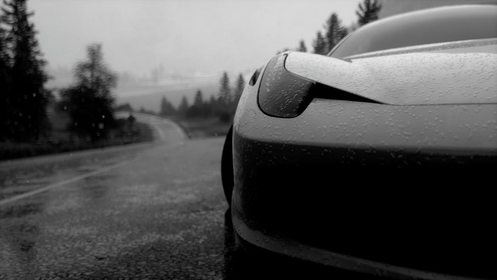 Monochrome sports car on a wet road