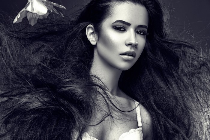 Monochrome portrait of a woman with long, flowing hair