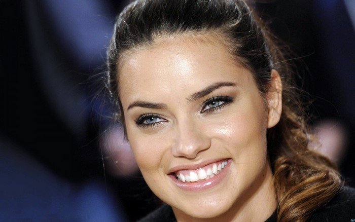 Adriana Lima smiling with blue eyes and brown hair