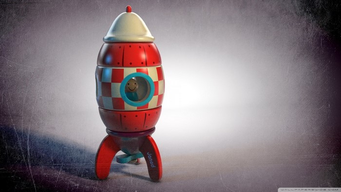 Red and white toy rocket with a smiling character
