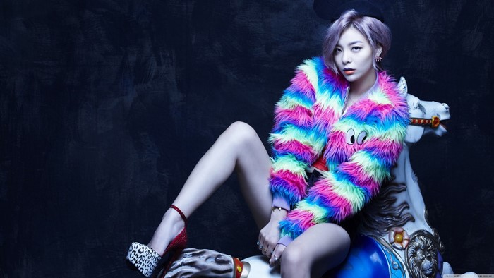 Ailee sitting on a carousel horse