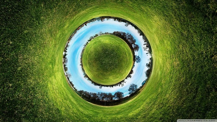Panoramic sphere of a grassy field with trees and sky
