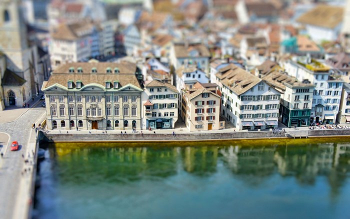 Tilt shift view of Zurich cityscape with river and old buildings