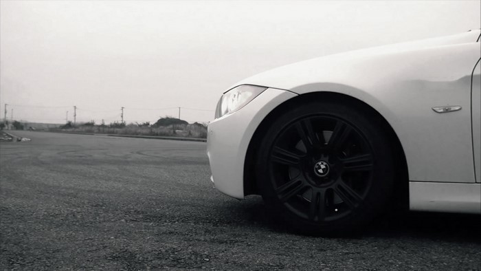 White BMW 3 Series E90 sports sedan on asphalt