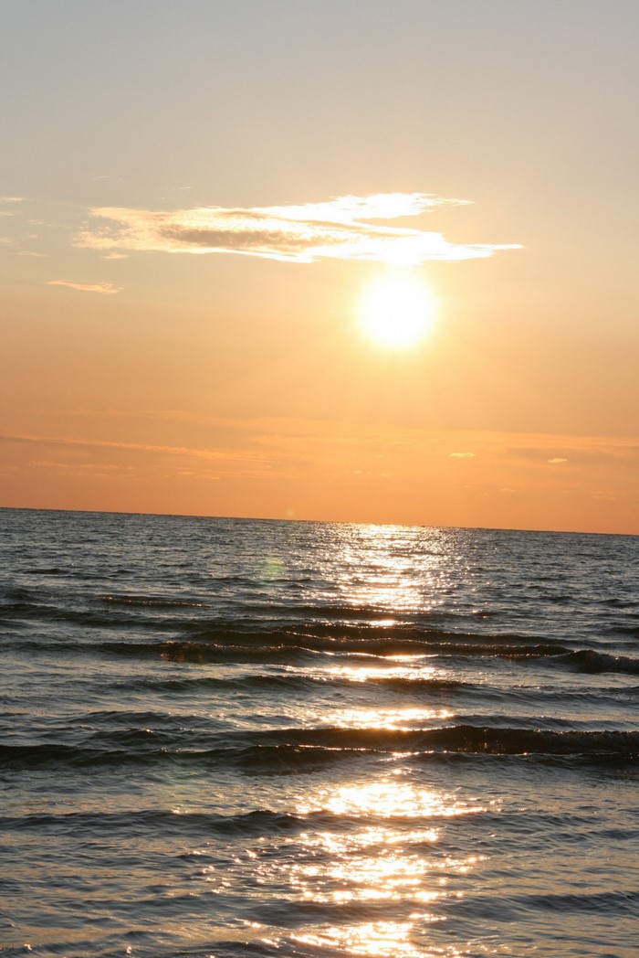 Sunset over the ocean with gentle waves