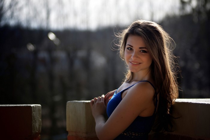 Woman in blue dress posing outdoors