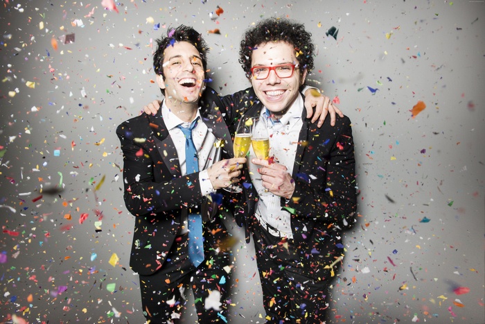Ian Axel and Chad Vaccarino celebrating with champagne