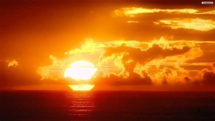 Sunset over the ocean with clouds