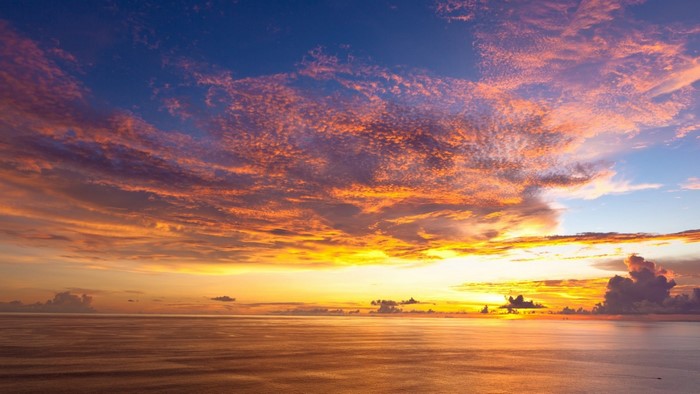 Sunset over the ocean with colorful clouds