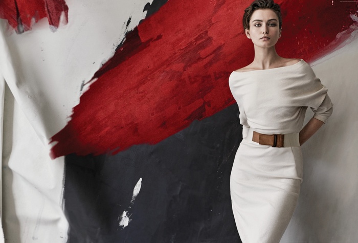 Andreea Diaconu in a white dress with a brown belt