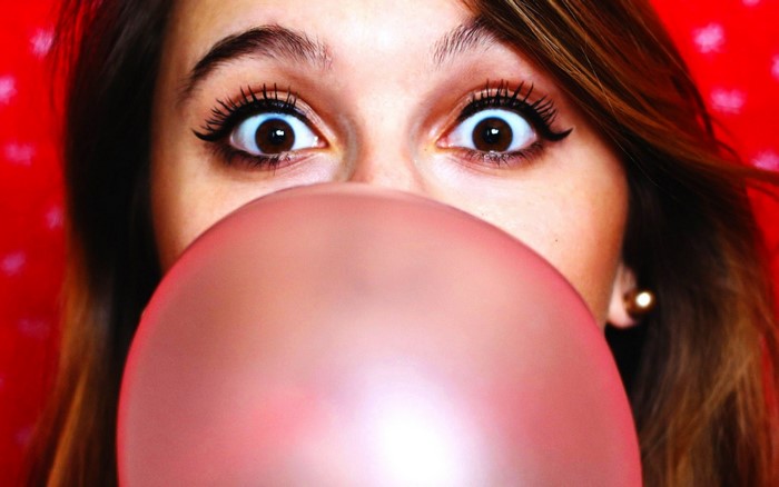 Girl blowing pink bubble gum