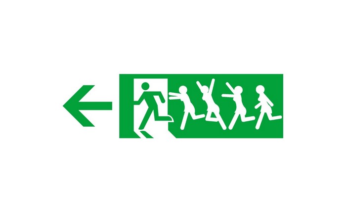 Green exit sign with running figures and arrow