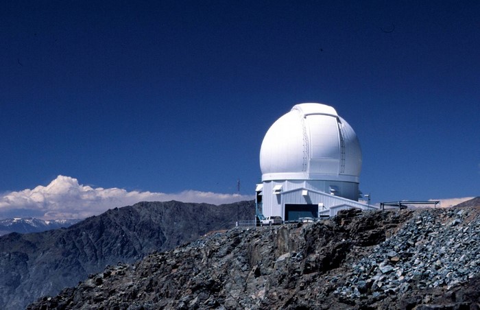 Observatory on a rocky mountain summit under a blue sky