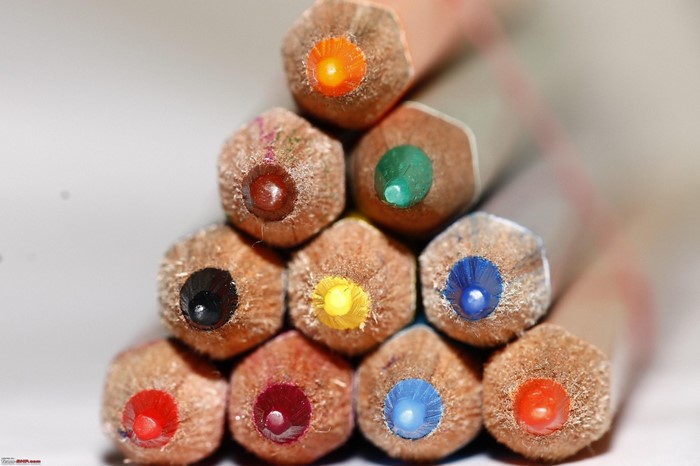 Close-up of colored pencil tips stacked in a pyramid