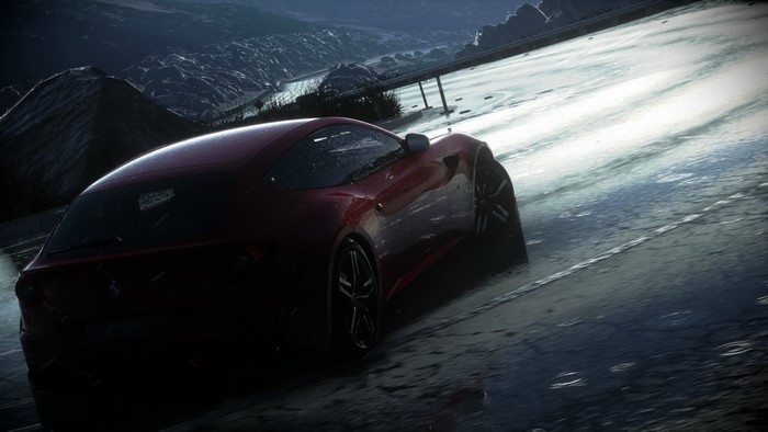 Red Ferrari sports car driving on a wet road