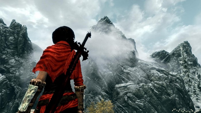 Character from The Elder Scrolls V Skyrim with sword in mountains