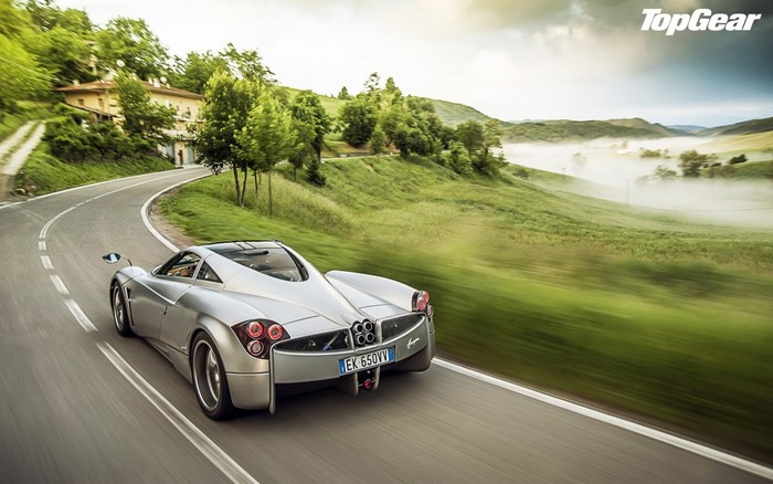 Pagani Huayra driving on a winding road in the countryside