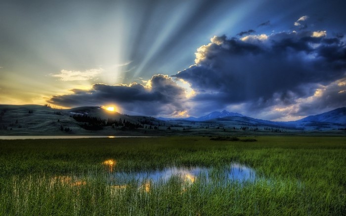 Sunset over Grassland with Mountain Silhouettes