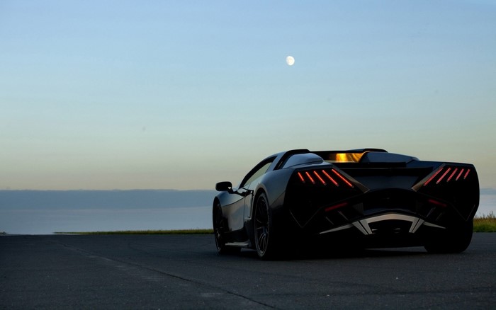Black Arrinera Hussarya sports car at dusk with moon