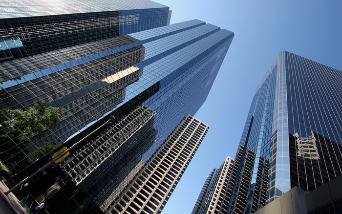 Modern skyscrapers with glass facades reflecting the sky