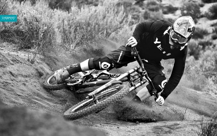 Downhill mountain biker in action on a dirt track