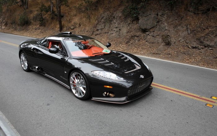 Black Spyker C8 Aileron sports car on a road