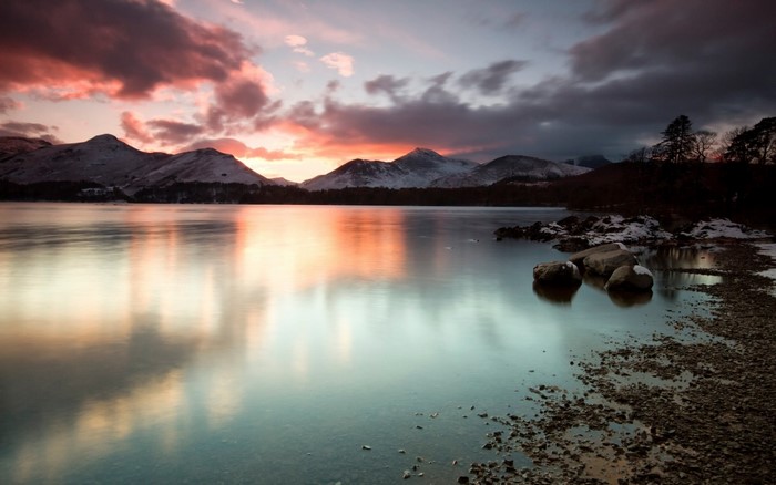 Sunset over a mountain lake with reflections